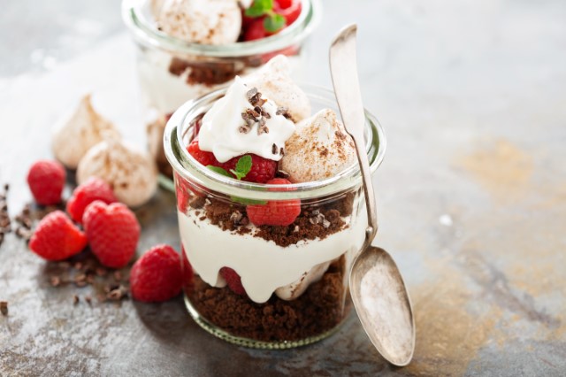 Fruit, crumbled cookies and whipped cream in a jar