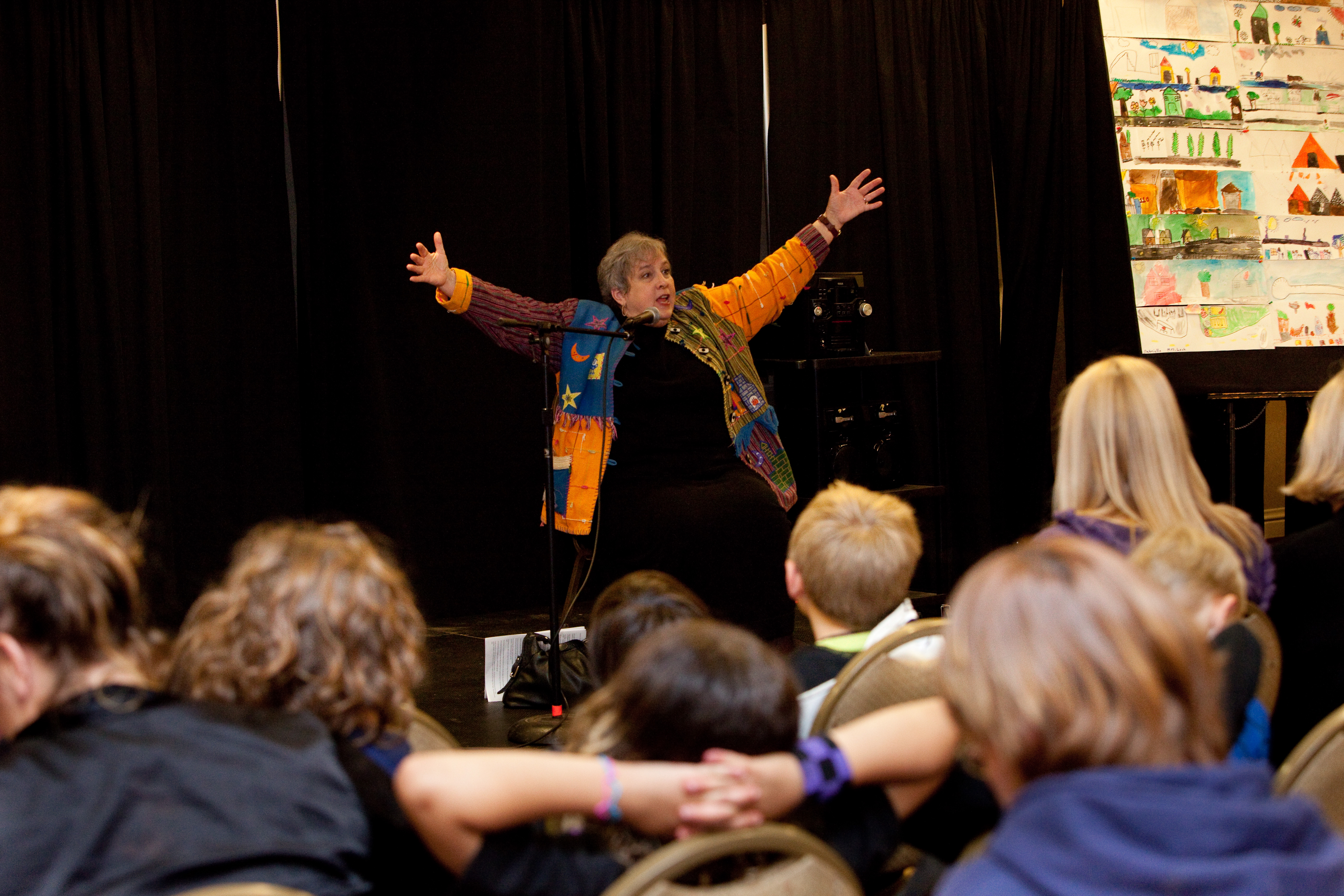 Photo of a woman telling a story to an audience