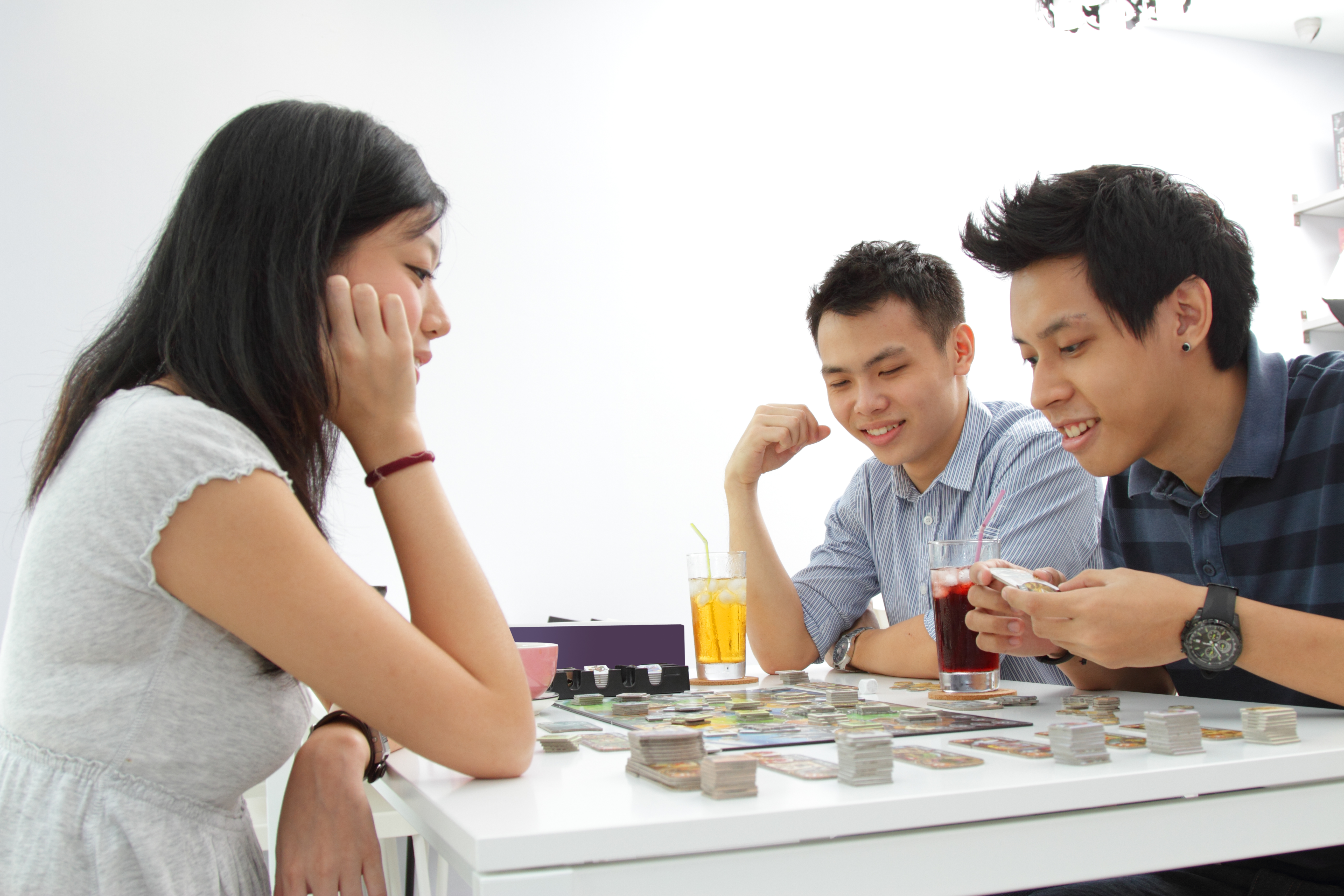 Three people playing a board game