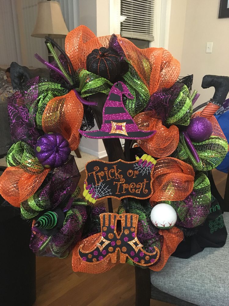 Orange, purple green Halloween wreath that says "Trick or Treat" in the middle.
