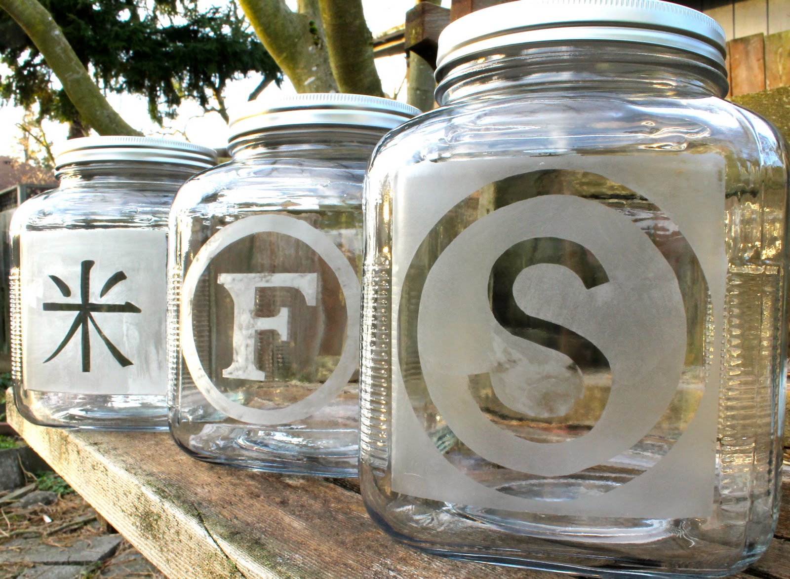 three glass jars with etchings