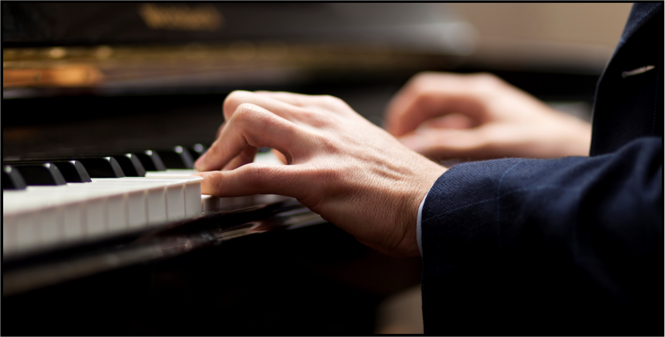 Close up of hands on piano keyboard