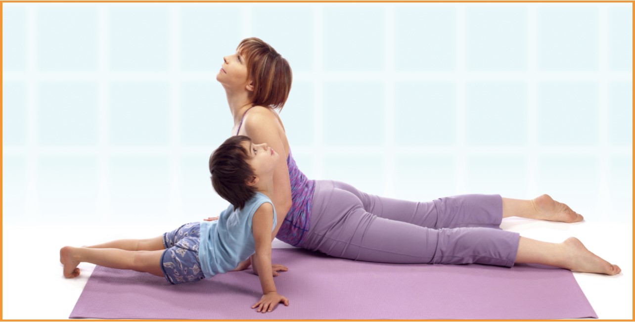 Teacher and child exercising Yoga