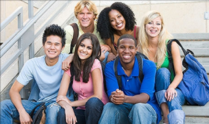 Smiling teens sitting together on steps