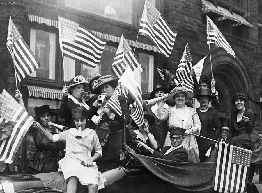 image of women waving flags for suffrage