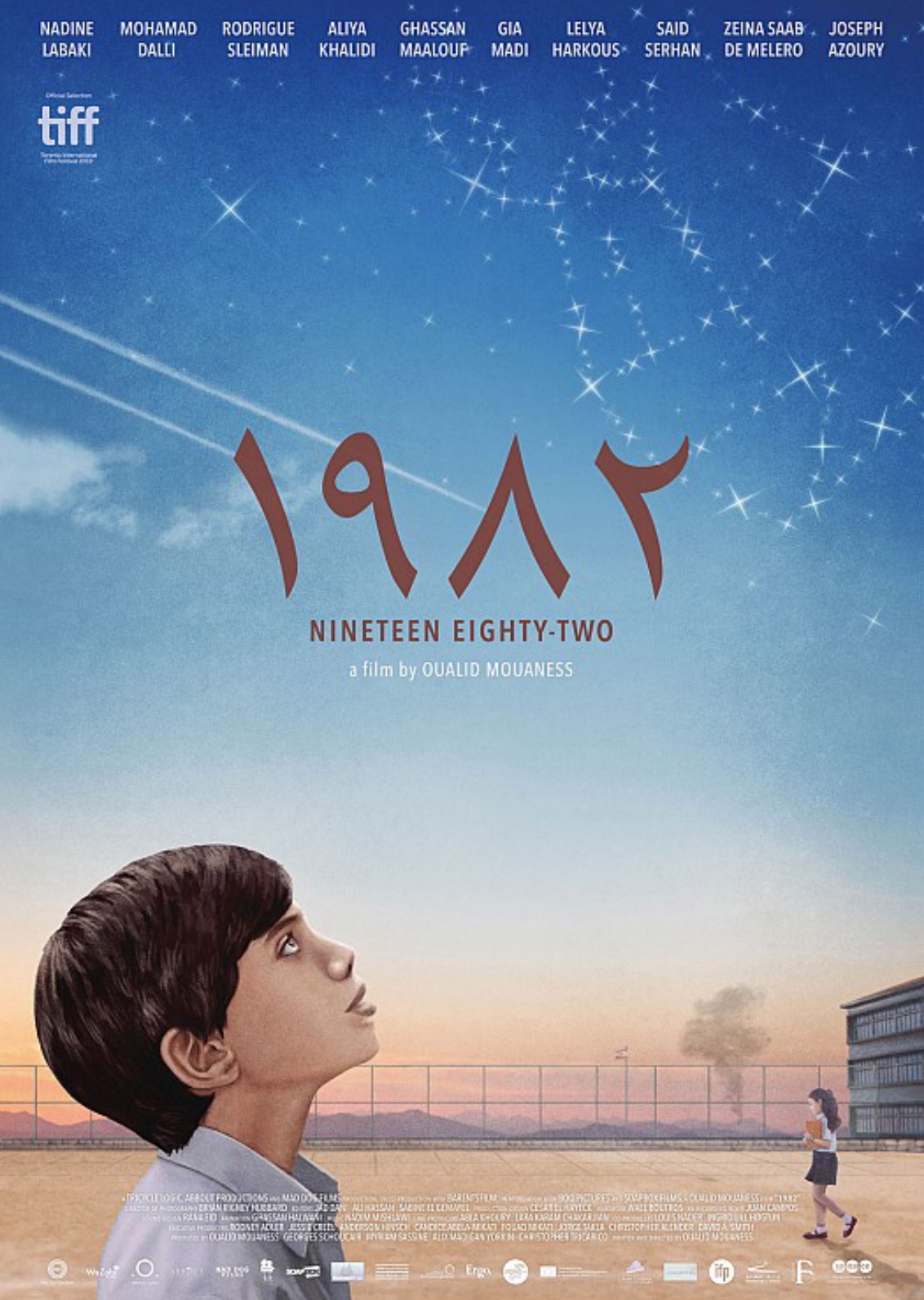 Movie poster for 1982; side view of a young boy looking at a constellation in the bright blue sky, a lone girl walks in the distant, dry field.