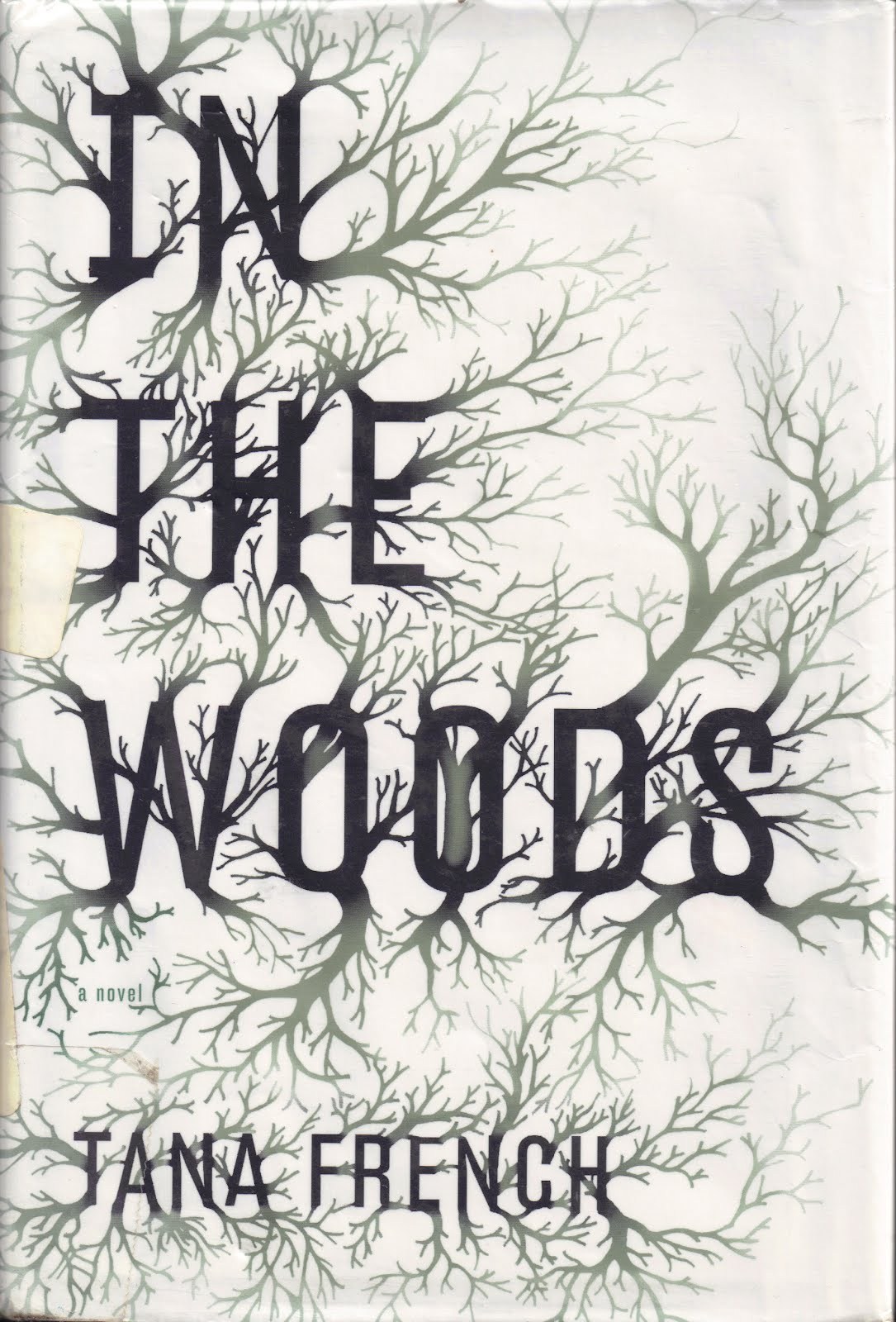 Cover of In the Woods by Tana French. Dark branches on a white background.