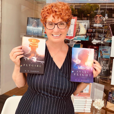 Image of Author holding her books.