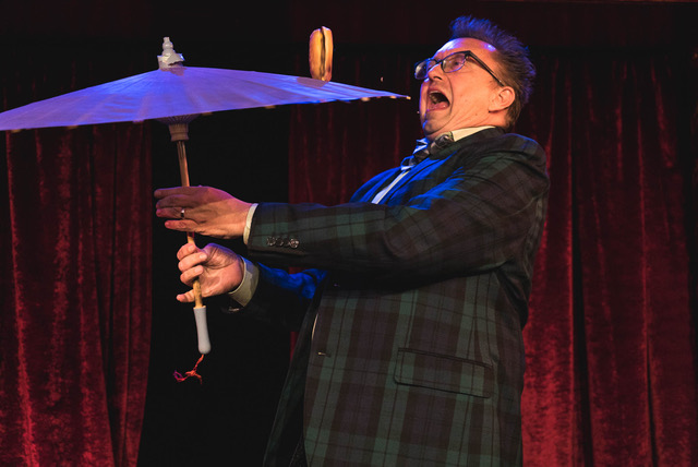 Michael Rayner spinning a hamburger on an umbrella