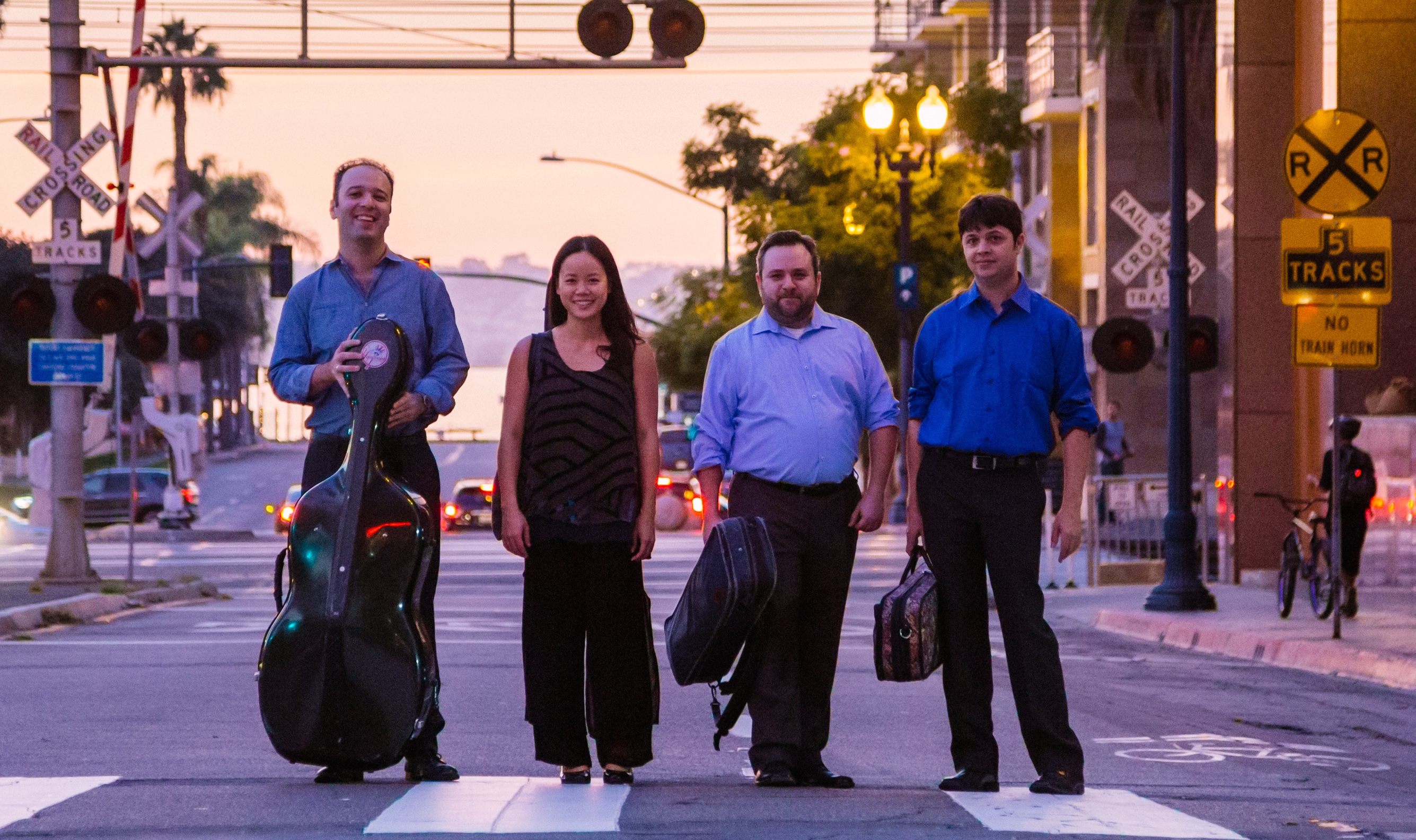 Hausmann Quartet members standing in crosswalk with instruments