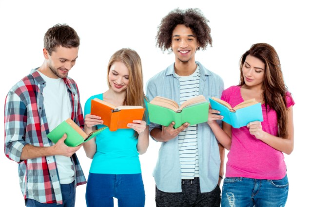 Four teens stand reading.