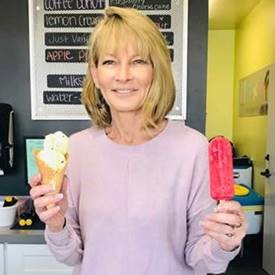 Dixie Hall holding an ice cream cone and a popsicle