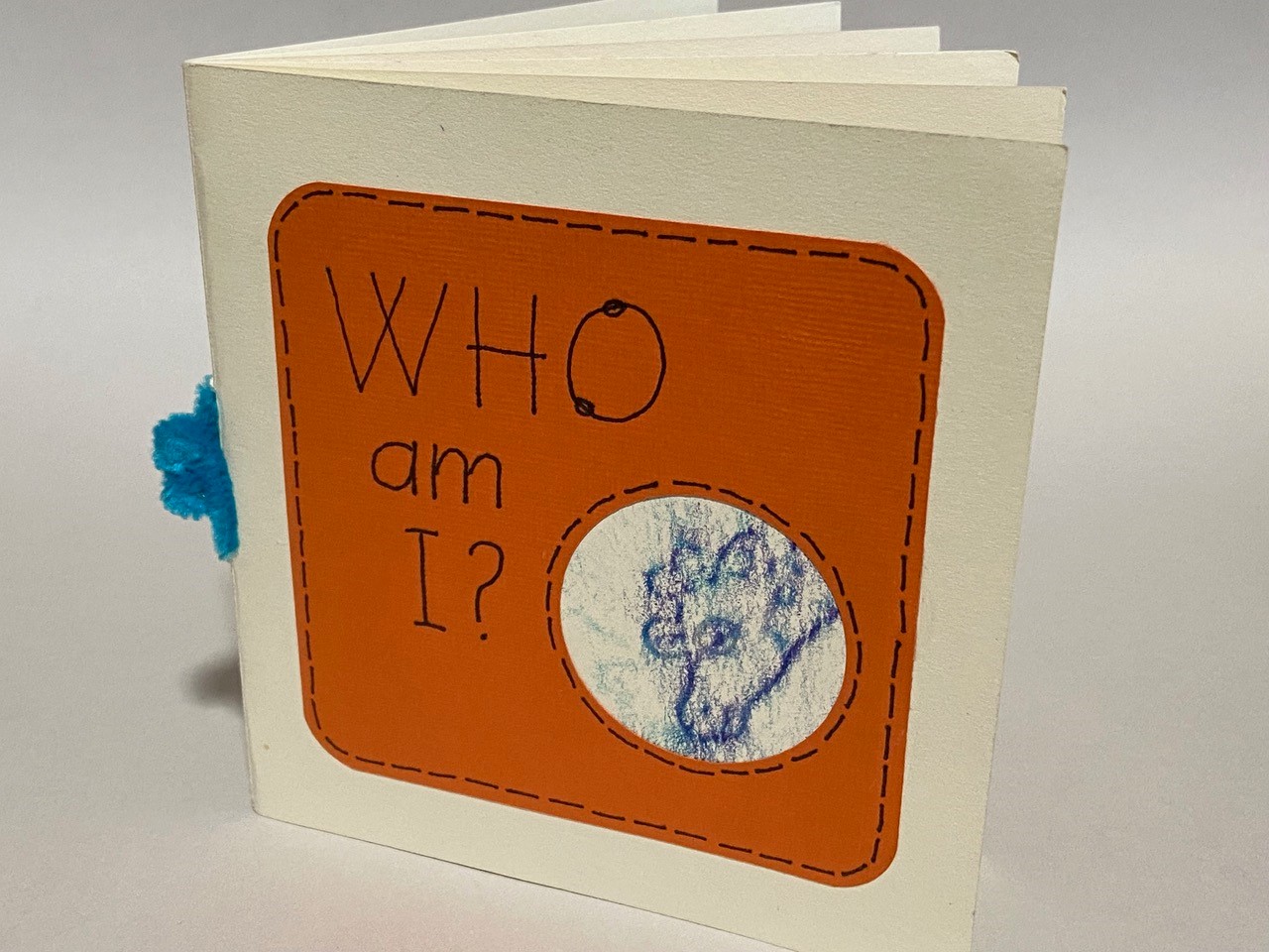 Hand made children's book entitled "Who Am I?" with a small photo of a giraffe on the cover