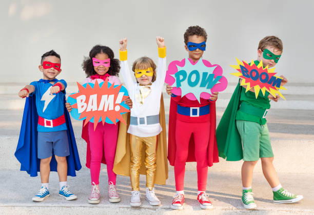 Kids in different colored superhero costumes holding signs
