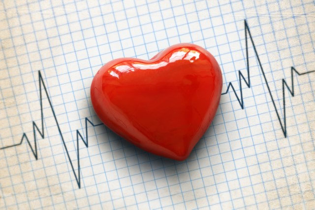 image of plastic heart laid over graph paper 