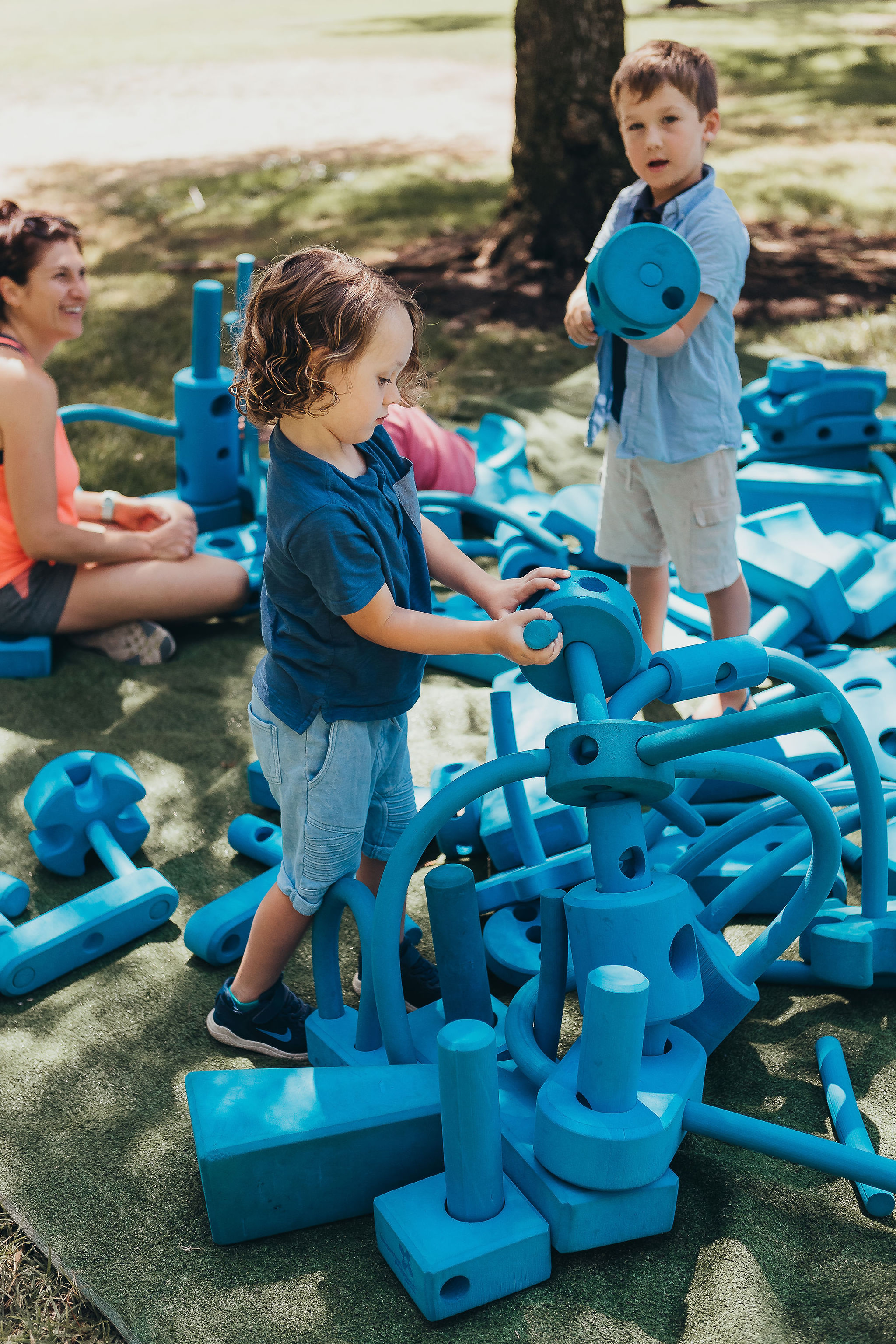 Children playing with blue building blocks 