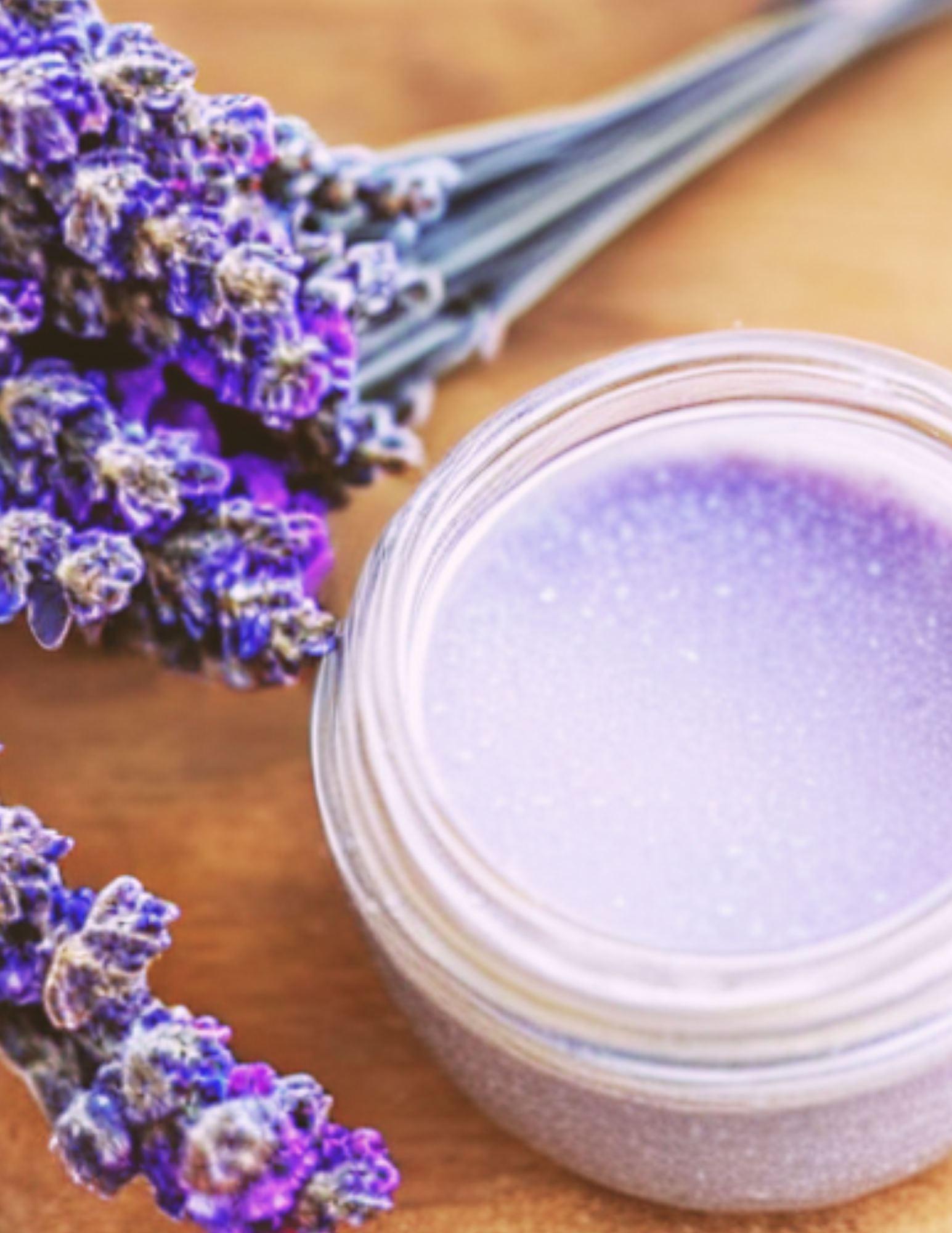 sprigs of lavender and a container of body scrub