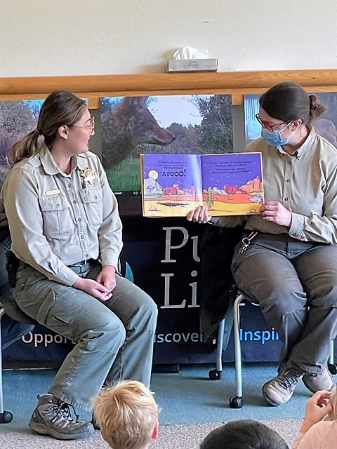 two park rangers read a story