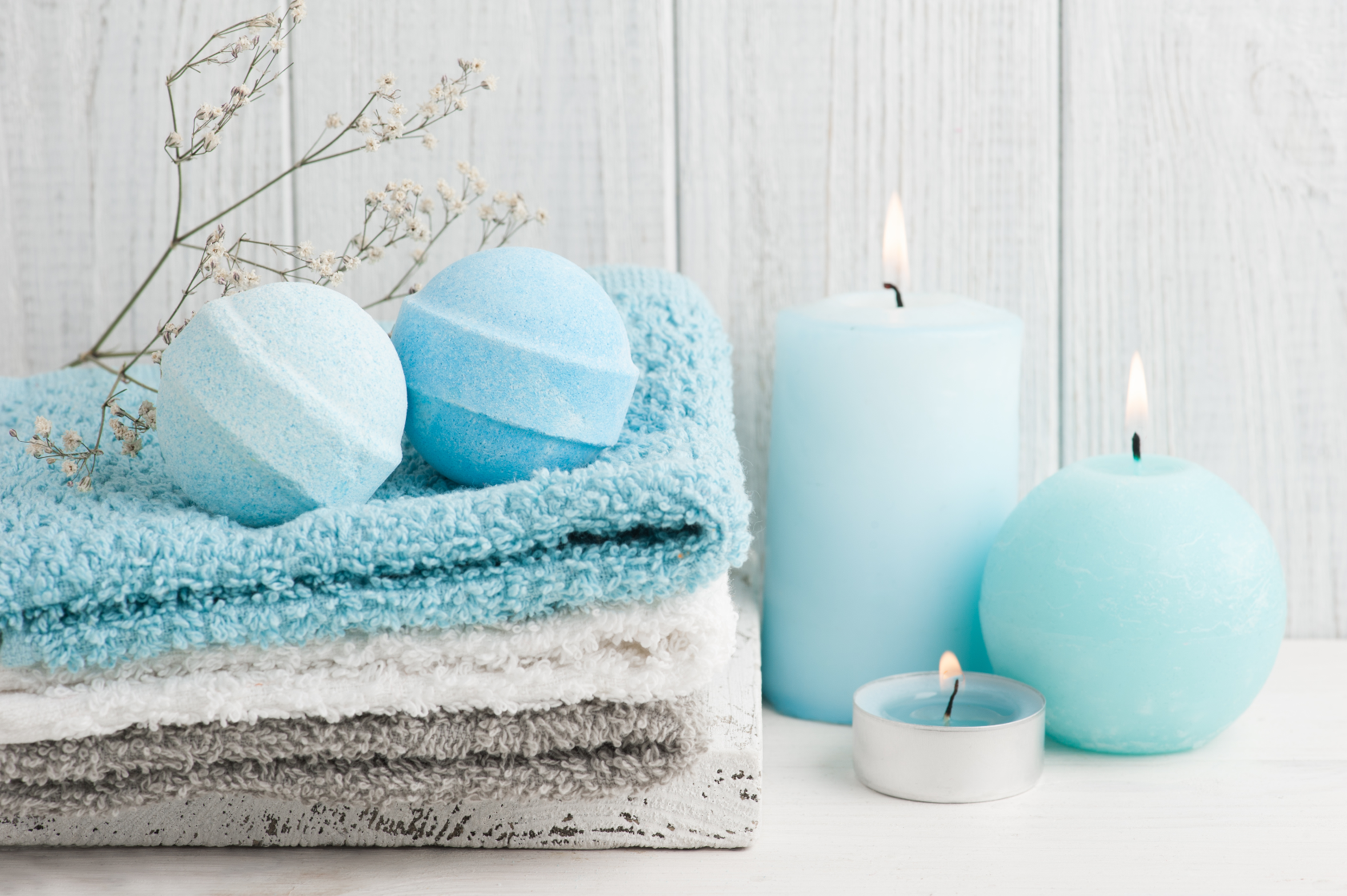 Blue bath bombs and candles on towels