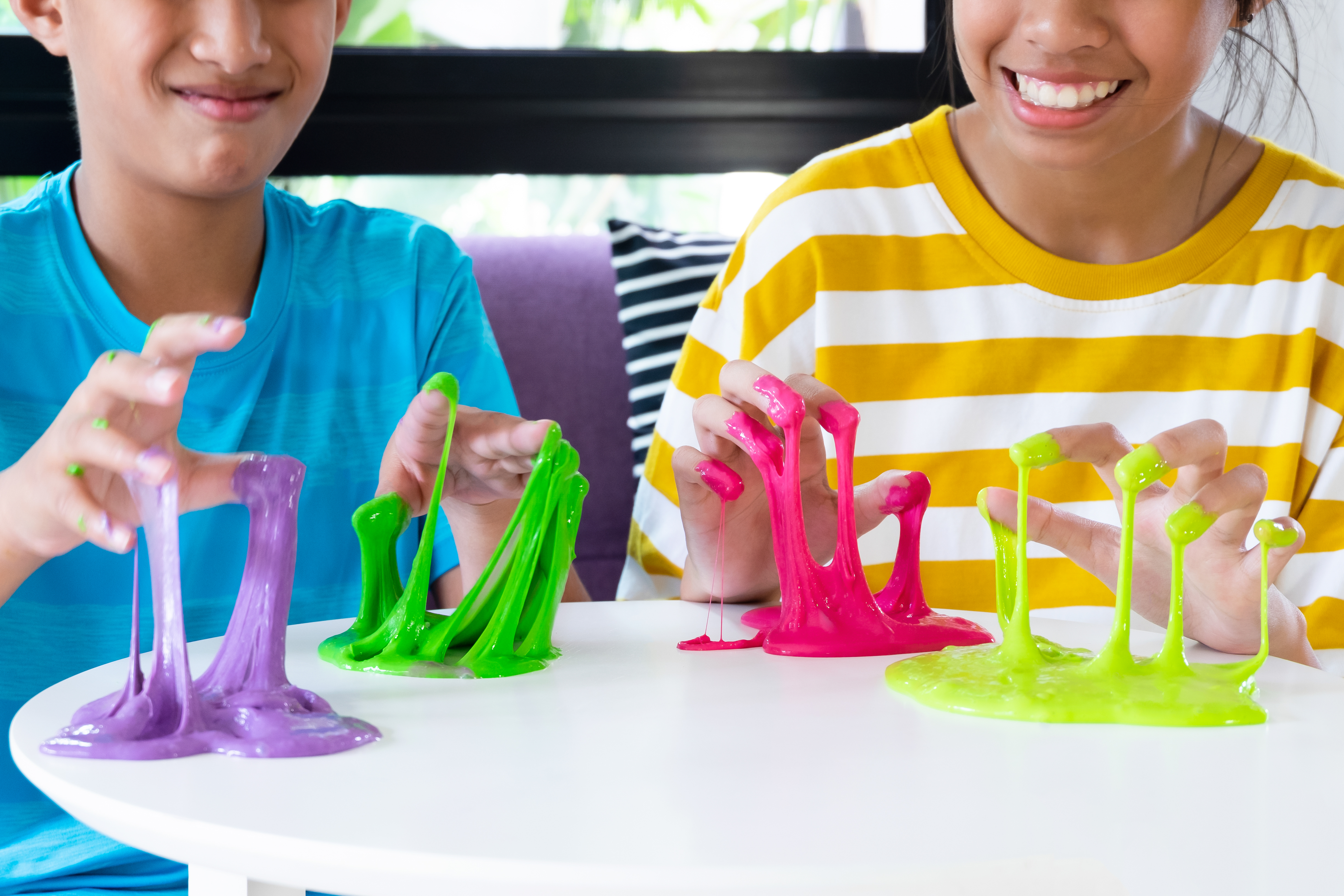 Two children playing with slime.