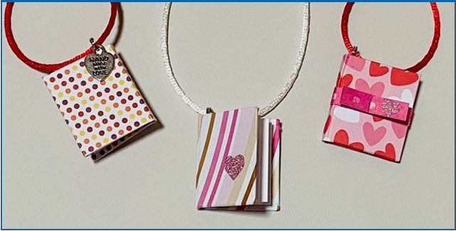Three mini book necklaces in pinks 