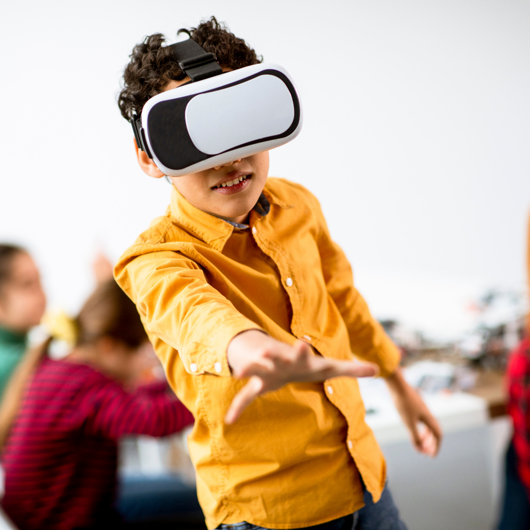 Child in yellow shirt participating in virtual reality.