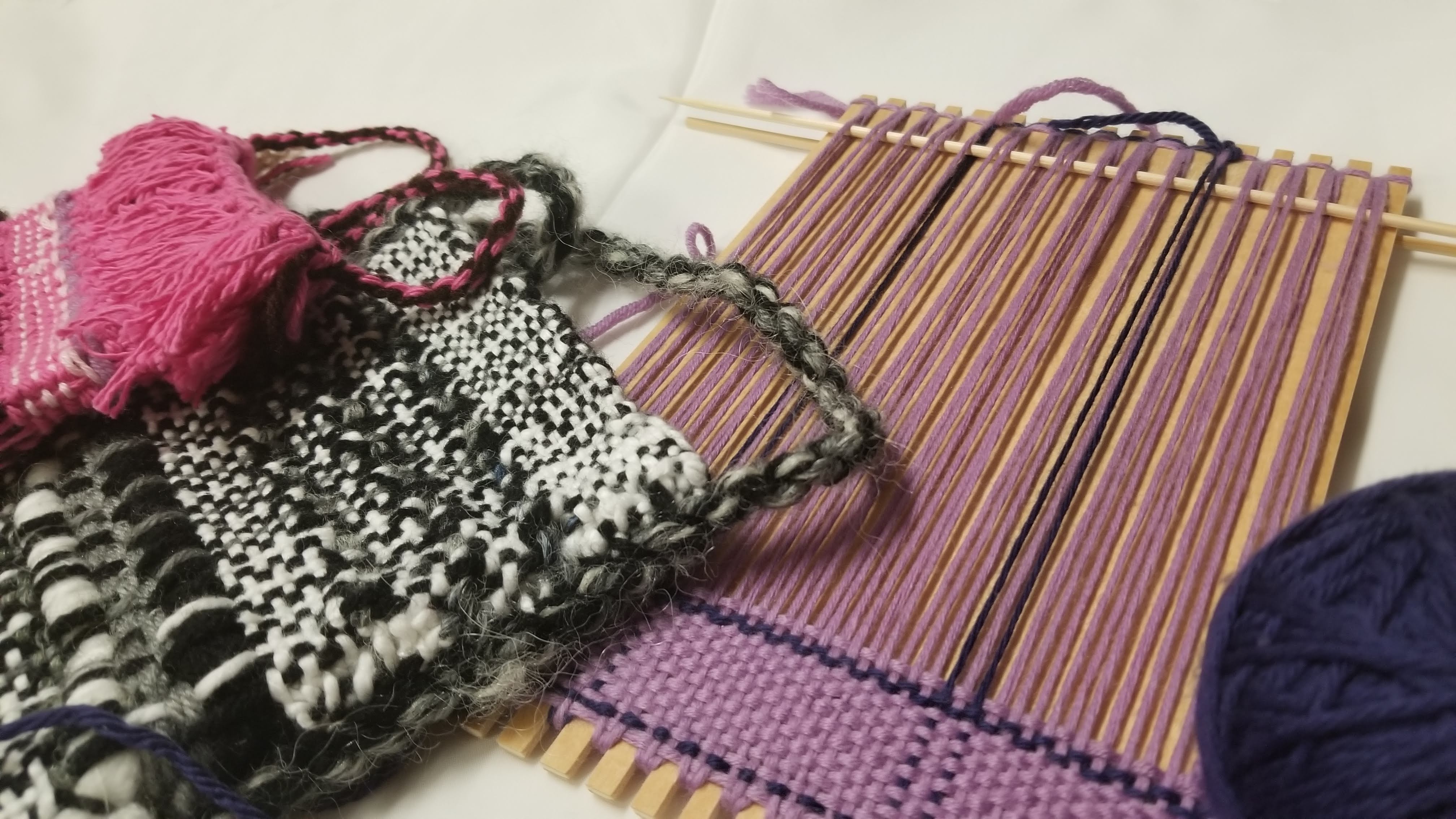 Two woven bags and a loom with yarn