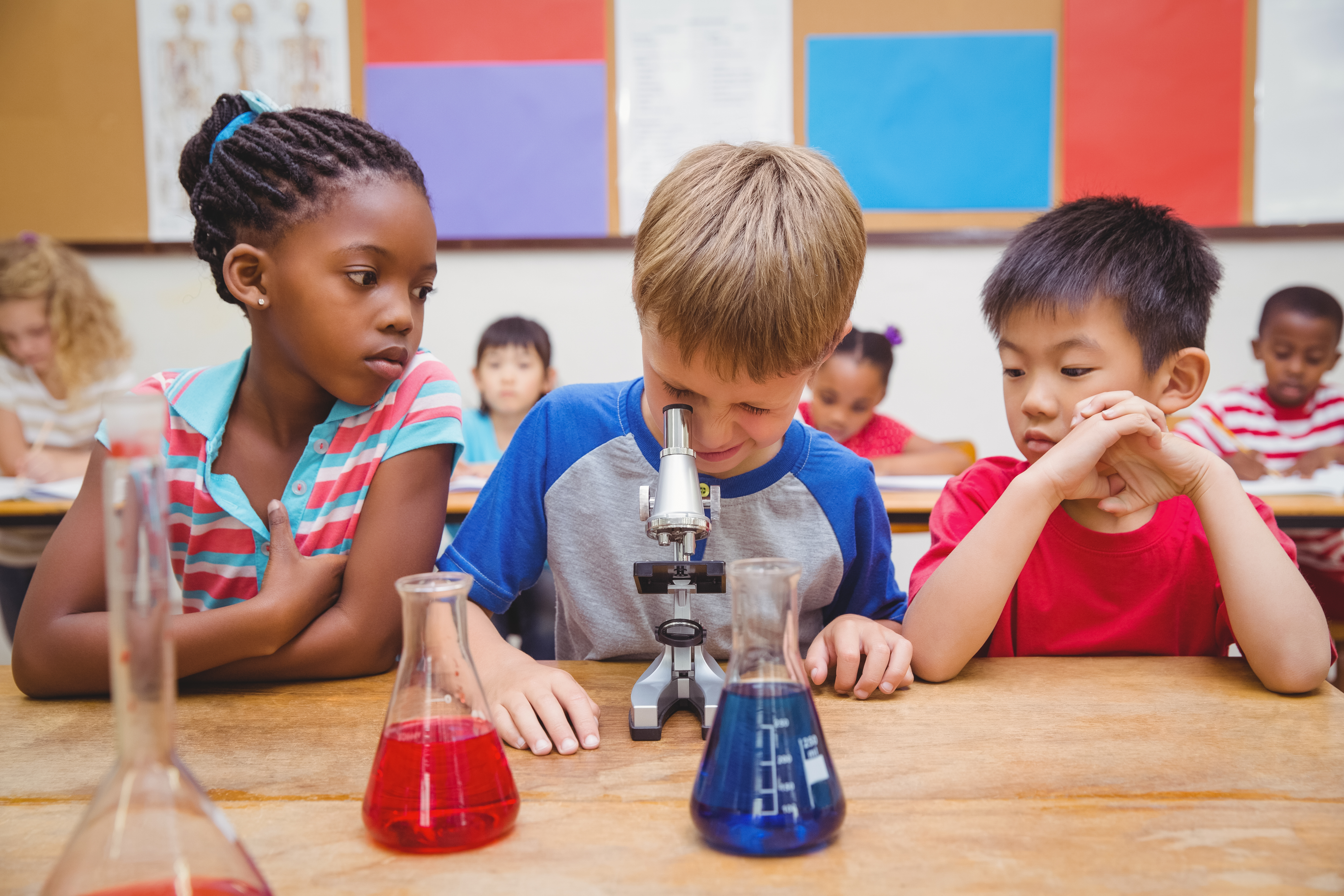 Kids using a microscope.