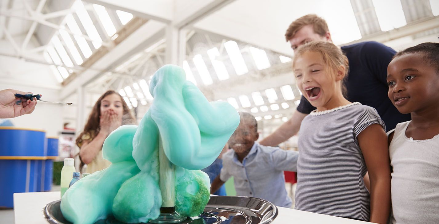 Children watching a chemical reaction know as "elephant's toothpaste"