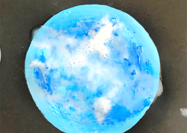A portrait of the moon made out of fizzy paint