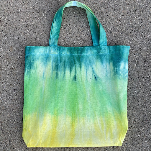 Photo of a fabric bag dyed in blues, greens, and yellows