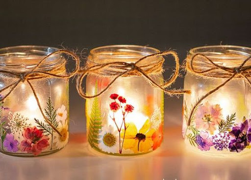 Photo of three illuminated jars decorated with twine and dried flowers