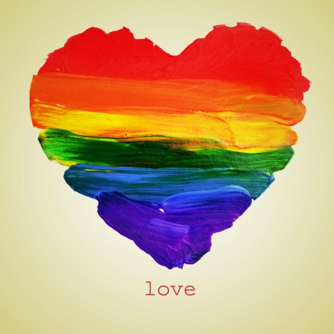 painting of a heart shape in rainbow colors with the word "love" printed under it
