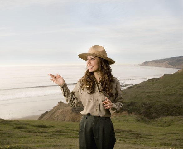 Female Park Ranger with ocean and coastline in the background