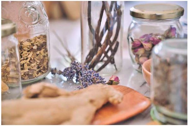Picture on various dried herbs in jars.