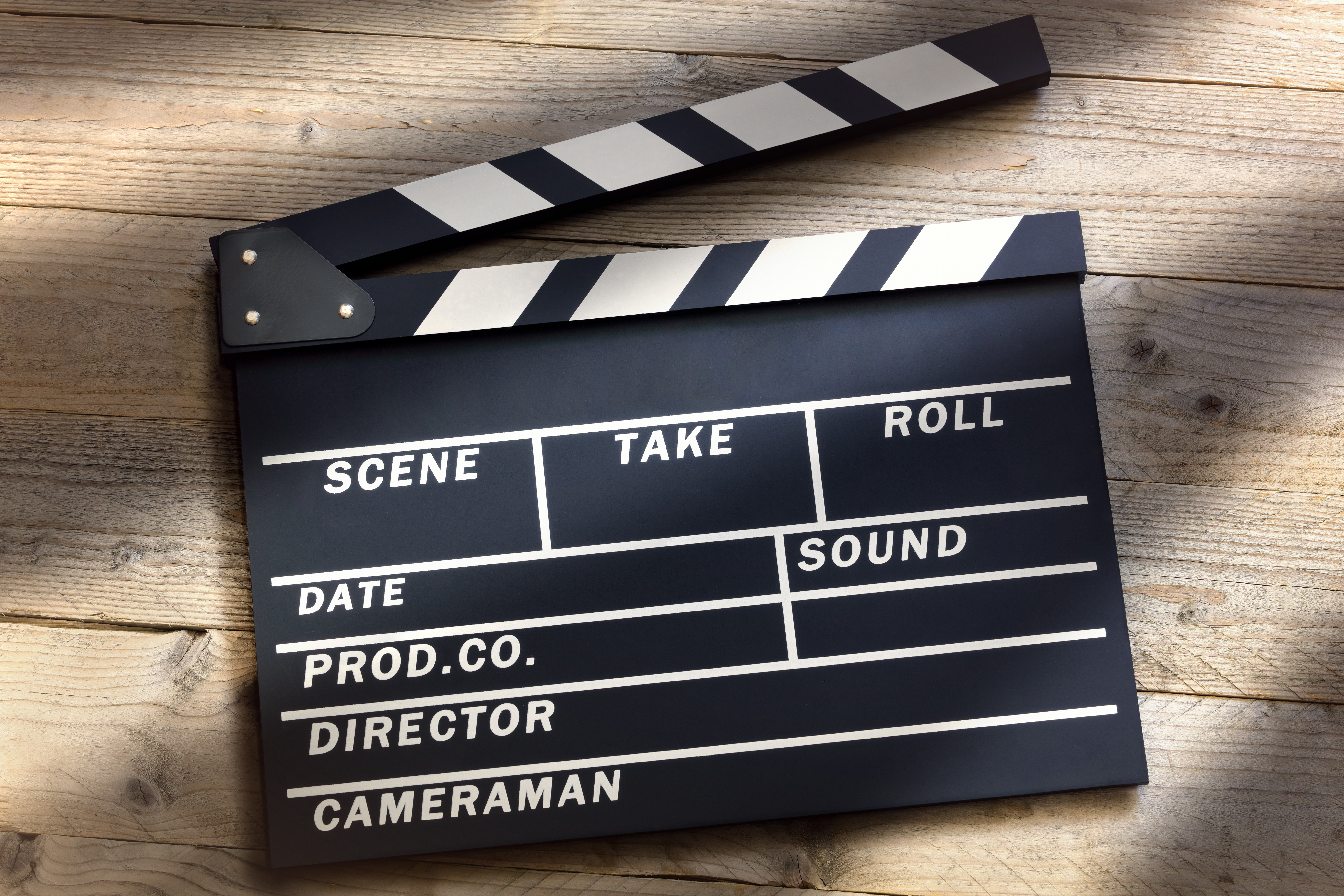 Movie film clap board against a wooden backdrop