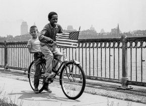 Black and white photograph of two kids on a bicycle by photographer Major Morris.