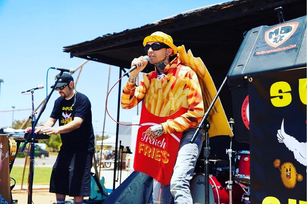 Picture of Microphone Doctors performing with singer wearing french-fry costume.