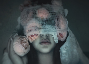 Photograph of a woman in a veil with roses over her eyes by artist Nathaly Alvizures.