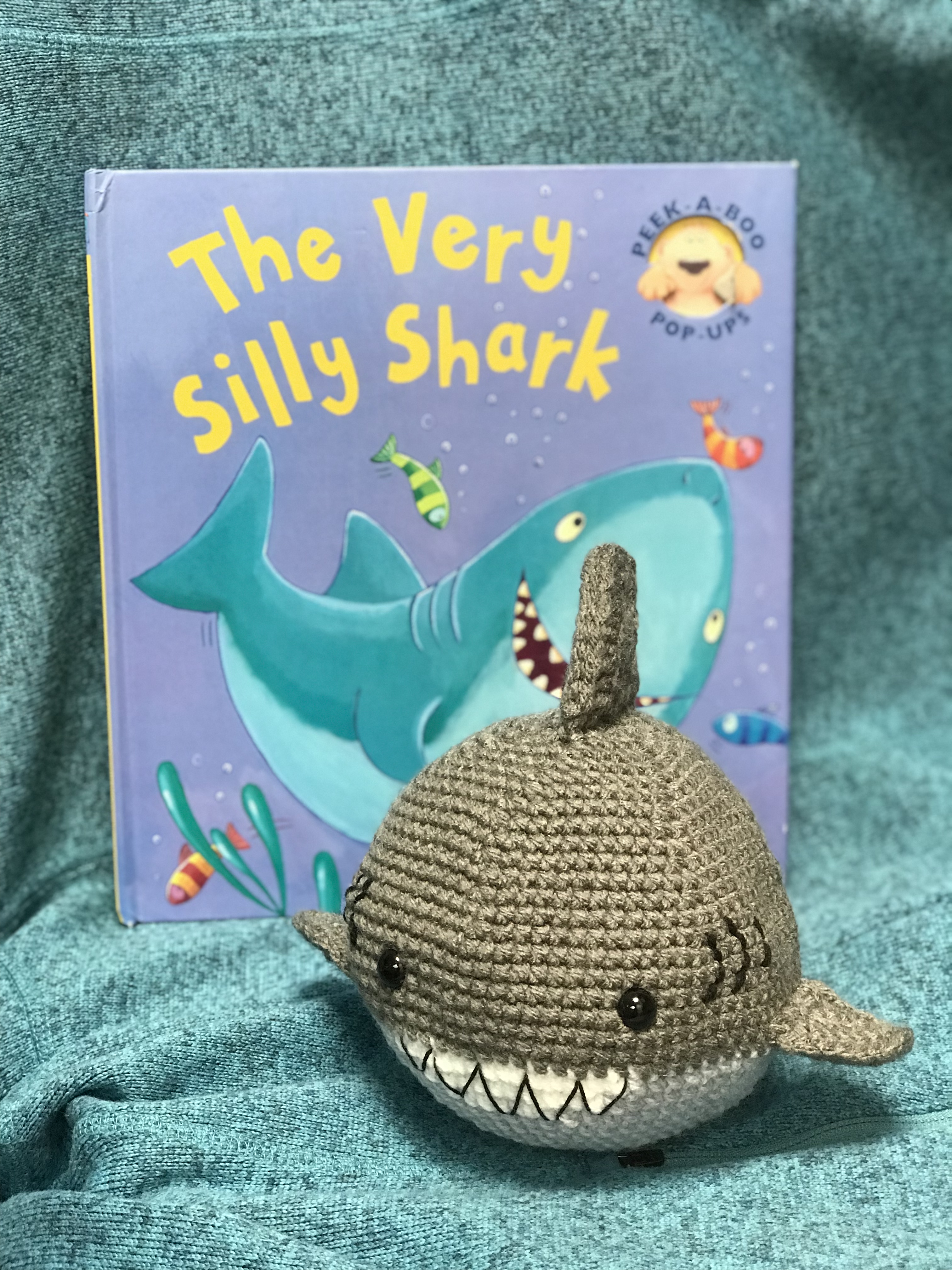 Crocheted shark and a shark children's book