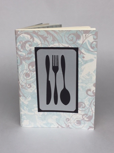 Handmade book with image of knife, fork, and spoon