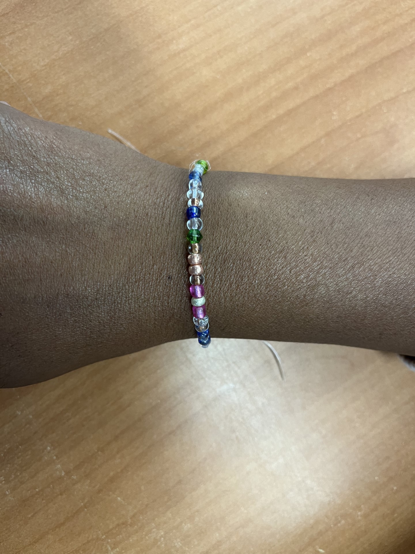 Wrist with a Morse code bead bracelet on it