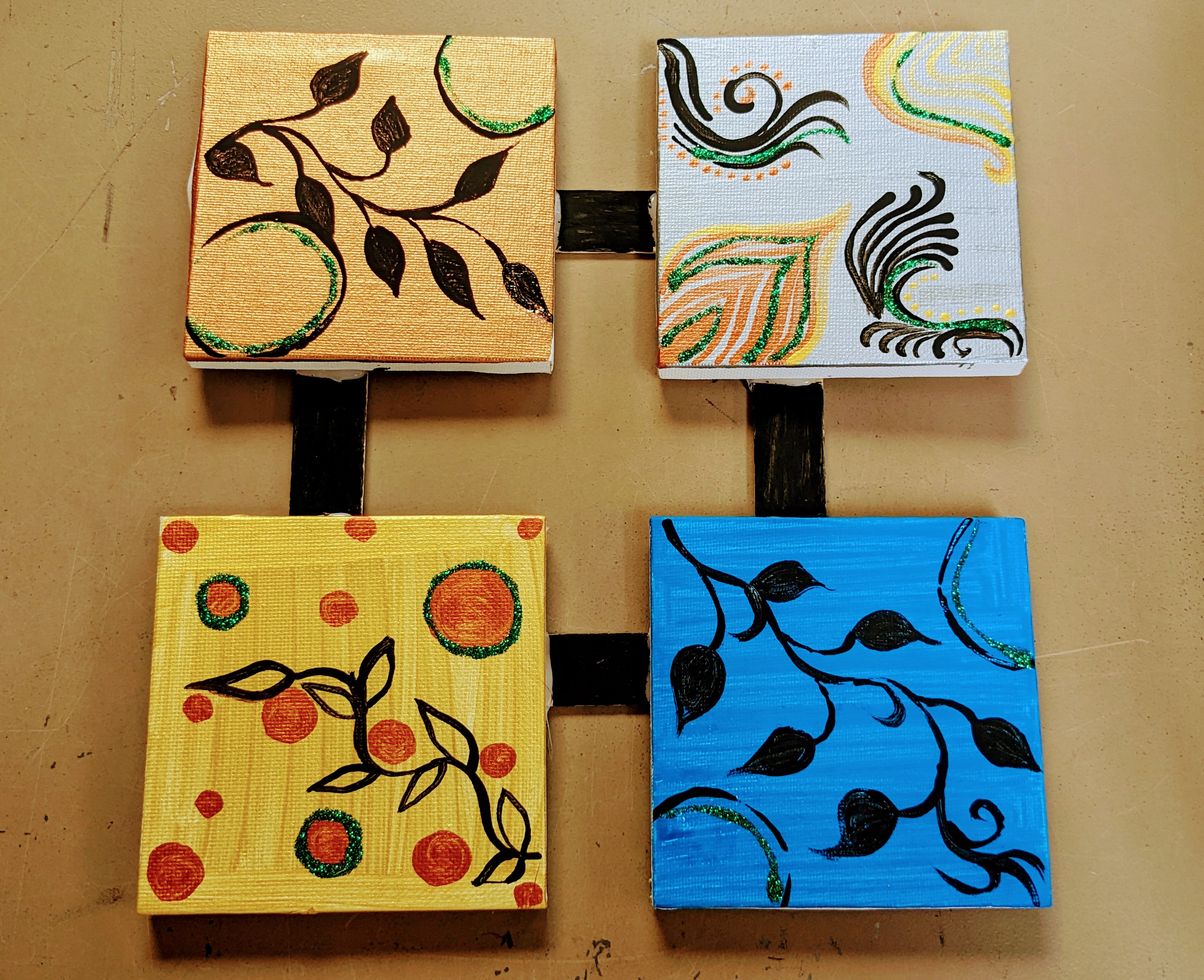 Four connected mini canvas frames that are painted