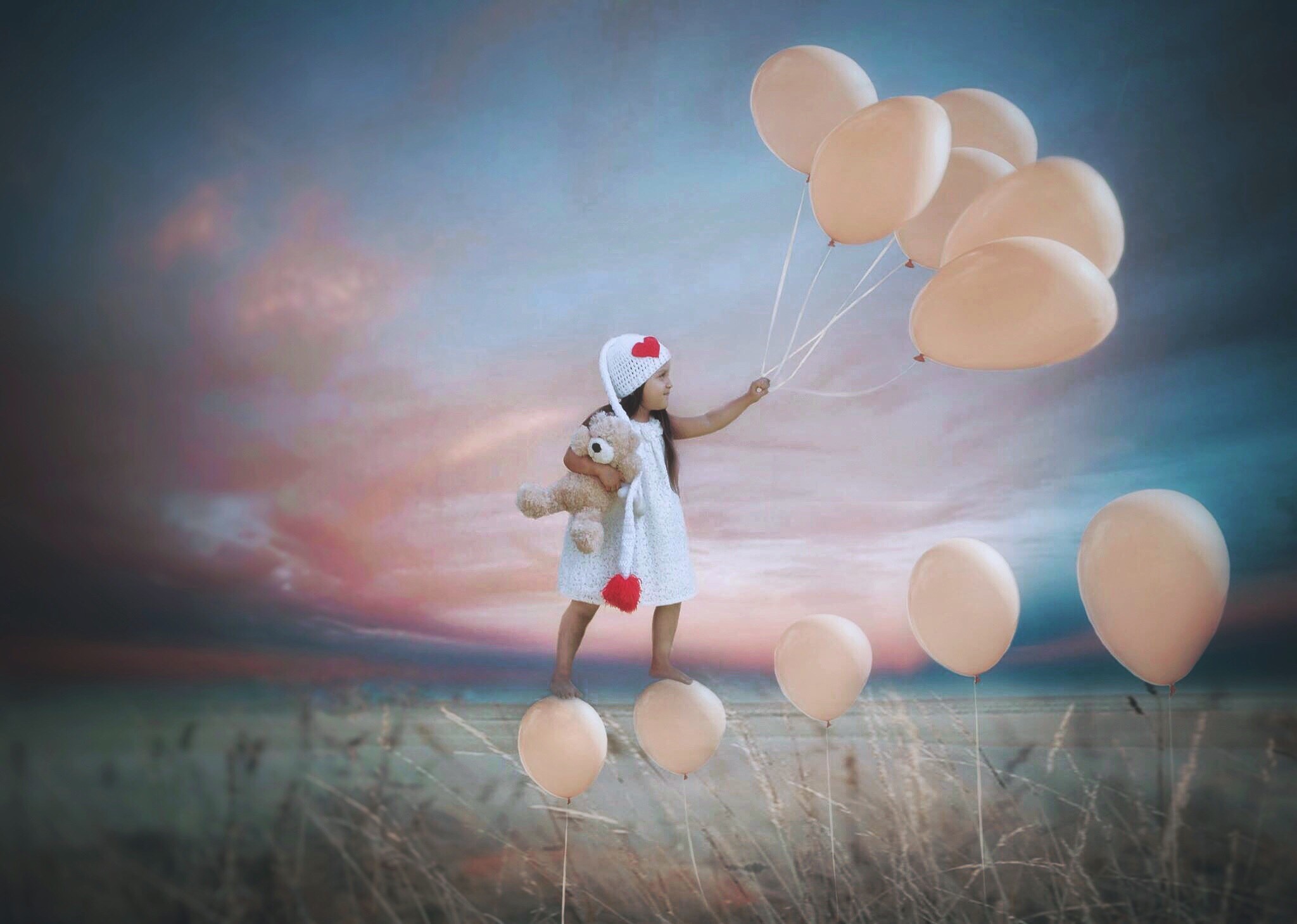 Nathaly Alvizures artwork, photo realistic image with child standing on balloons 