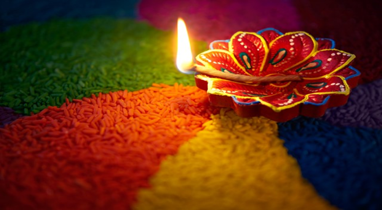 Color wheel of rice with a lit incense stick on a decorative plate