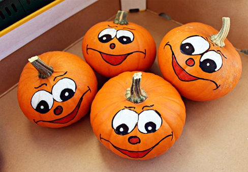 Four pumpkins with painted faces