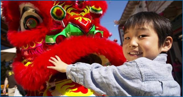 Young Asian boy with dragon dancer.  