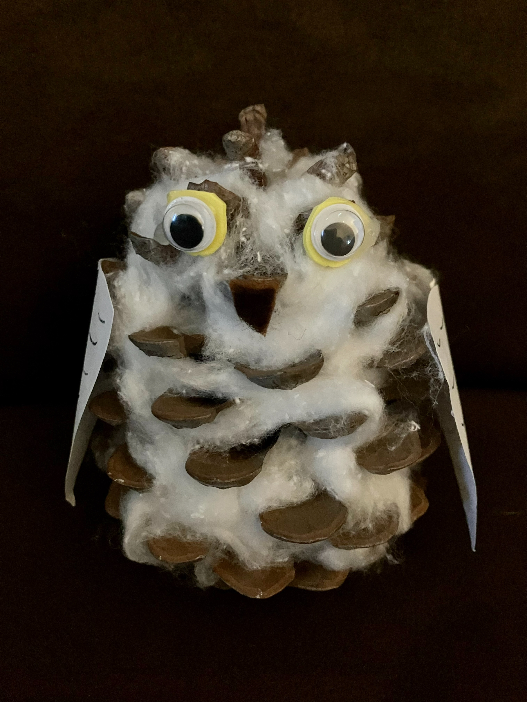 pine cone covered in cotton that looks like an owl