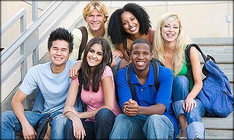 Teen students posing for photo on exterior staircase