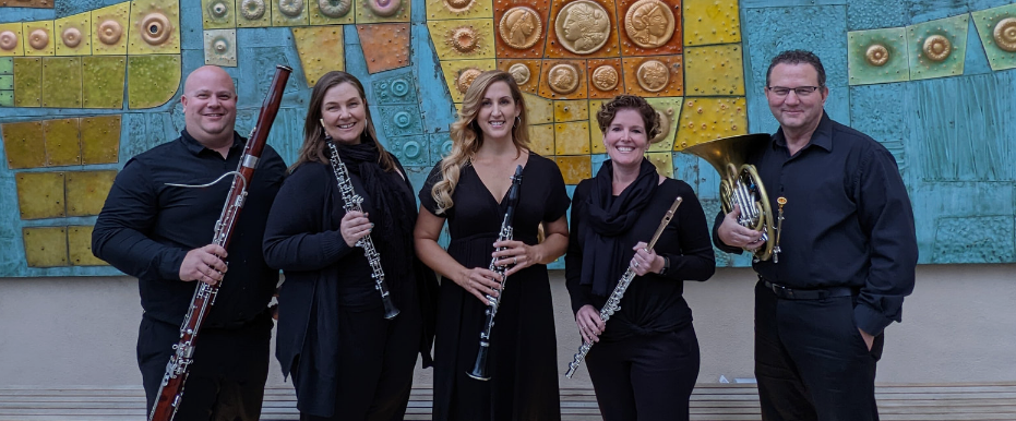 Photo of 5 musicians holding brass and woodwind instruments